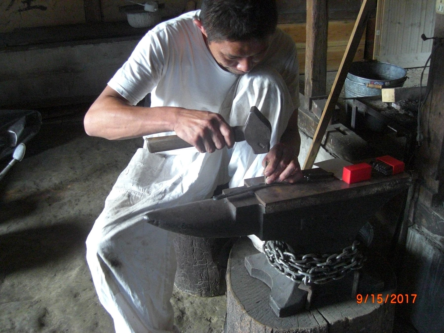 Japanese craftsman working at a forge
