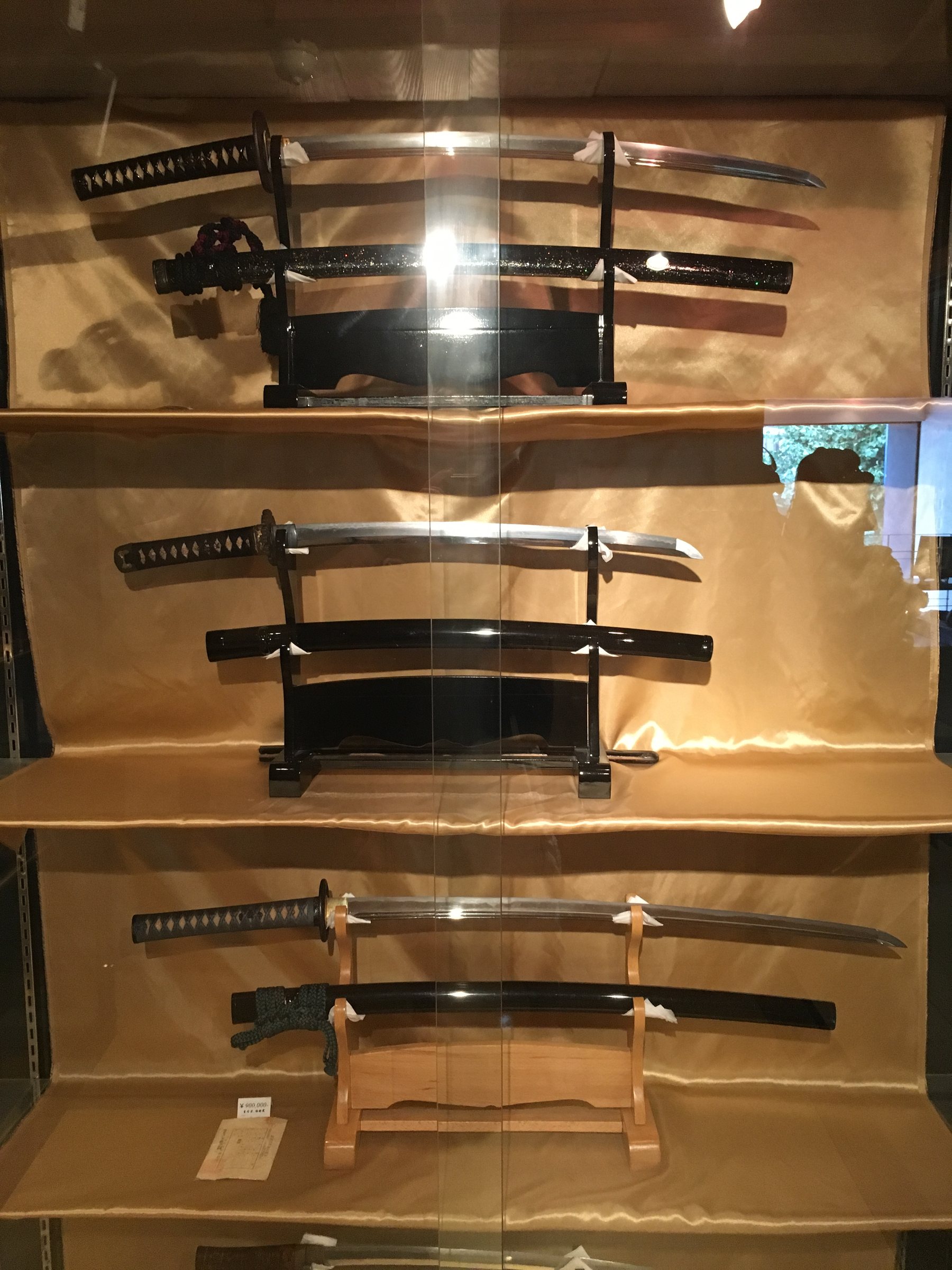 Japanese sword display showing blades and fittings